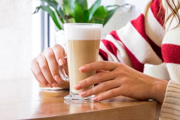 Girl having glass of coffee