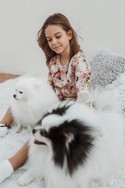 Girl and her dogs on the bed