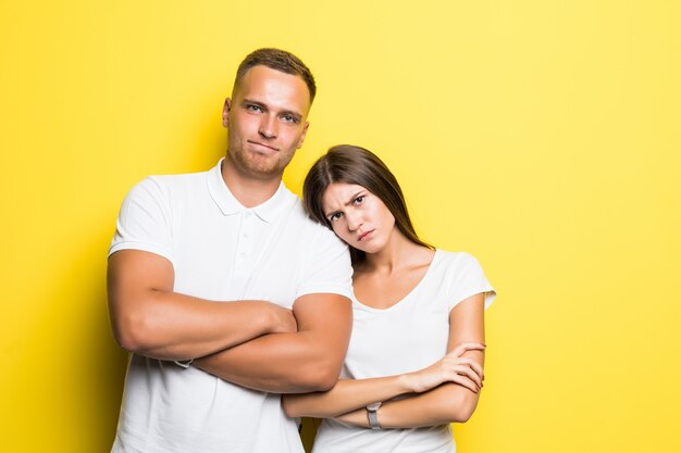 Girl hold her head on boyfriends shoulder while looking in the camera little bit upset isolated on white