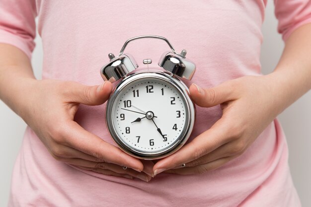 Girl holding an alarm clock