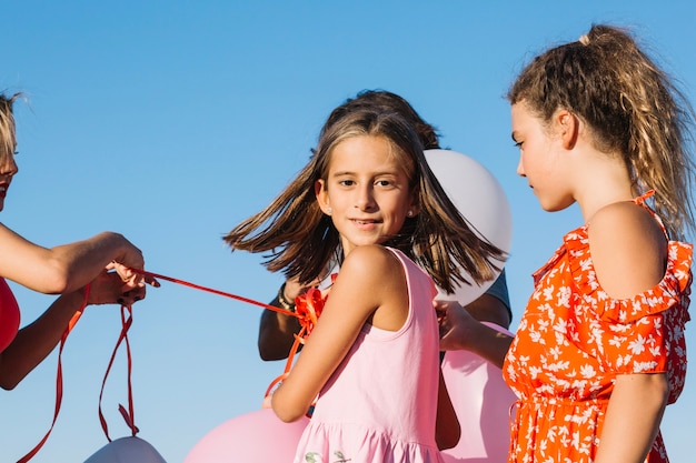 Girl holding balloons