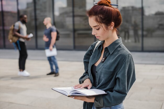 Free photo girl holding book reading standing