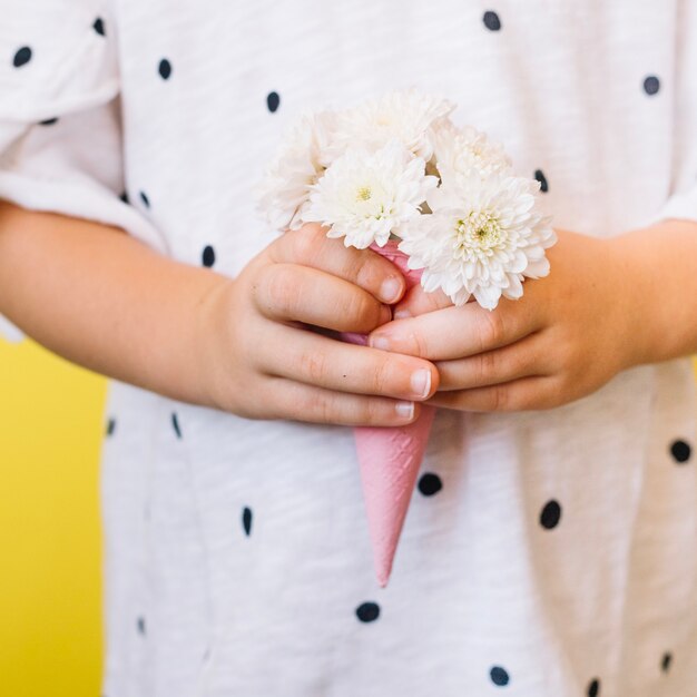 Girl holding bouquet in cone