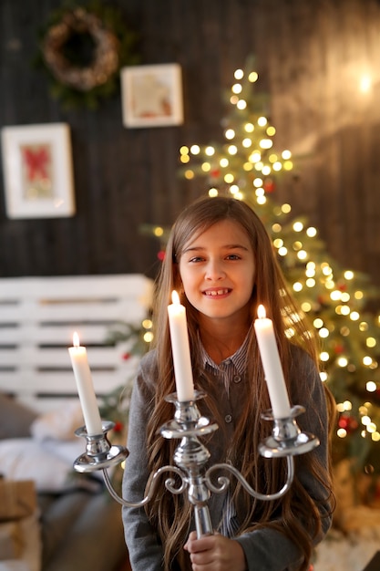 Free photo girl holding candlestick