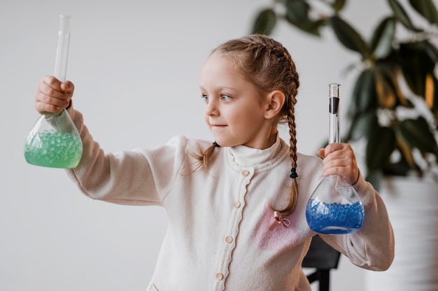 Free photo girl holding chemical elements in recipients