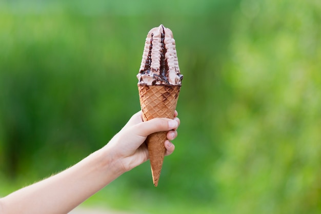 Girl holding chocolate and syrup ice cream