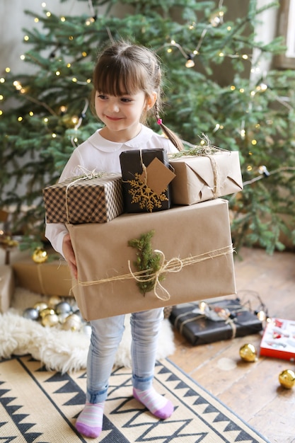 Girl holding Christmas present in Christmas Day