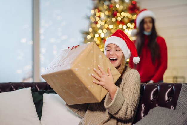 Girl holding a Christmas present on New Years Eve.