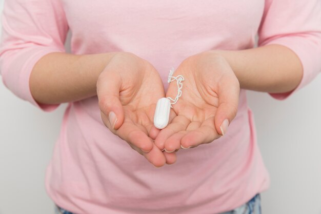 Girl holding a clean tampon