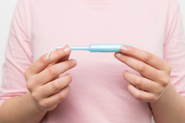 Girl holding a clean tampon