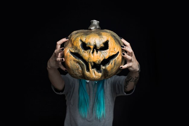 Girl holding creepy pumpkin