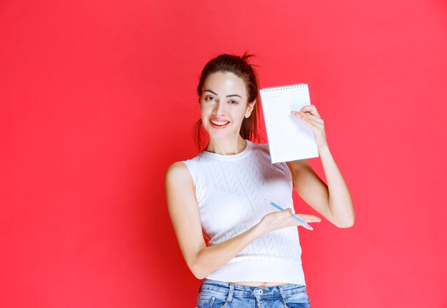 Girl holding and demonstrating her exam sheet. 