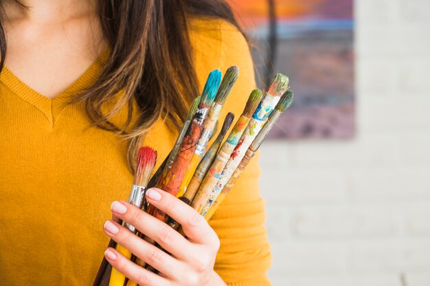 Girl holding dirty brushes