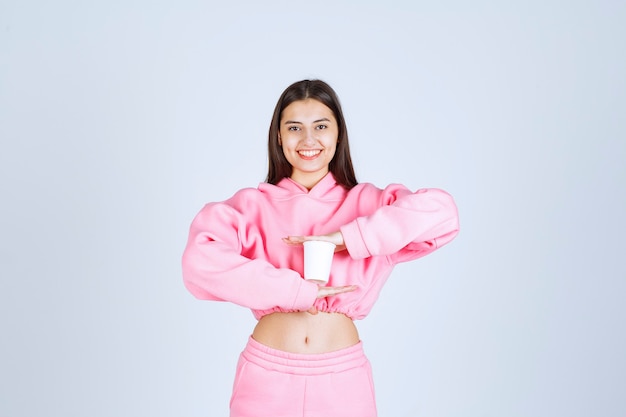 Girl holding a disposable coffee cup with both hands