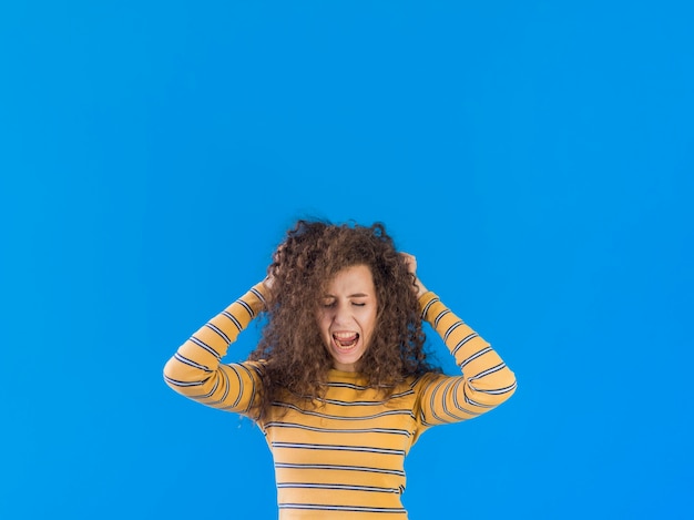 Girl holding her curly hair copy space