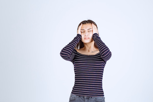 Girl holding her head as she is tired or has headache. 