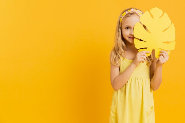 Girl holding leaf with copy space