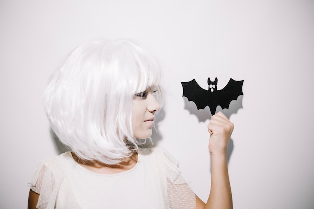 Free photo girl holding paper bat