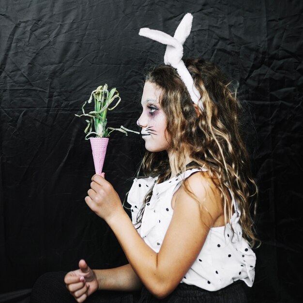 Girl holding pink cone with onion