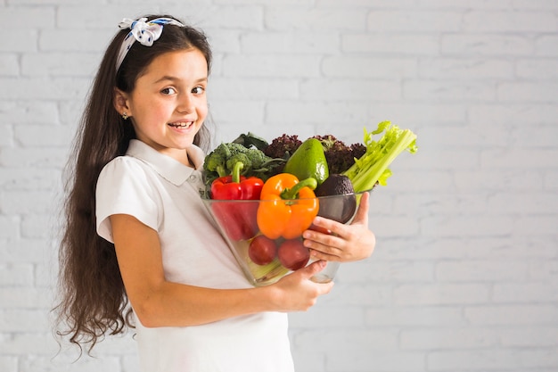 Girl holding ripe banana and citrus lemon