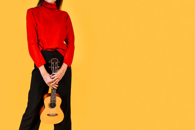 Free photo girl holding an ukelele