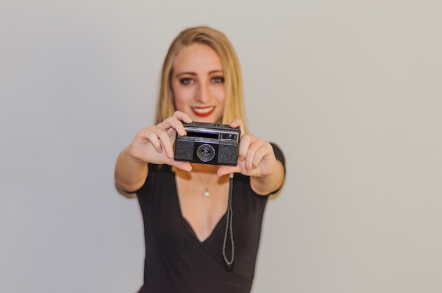 Free photo girl holding vintage camera