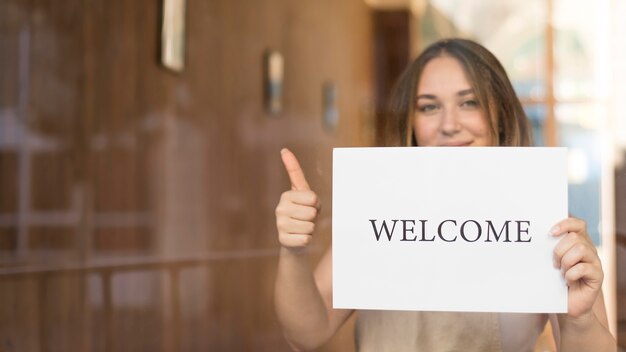 Girl holding a welcome sign after the end of quarantine