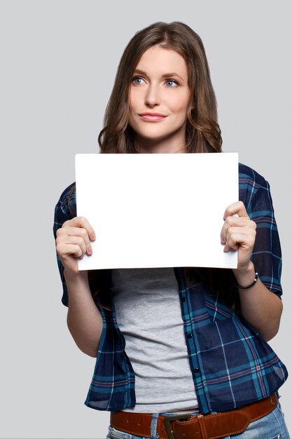 Girl holding white billboard