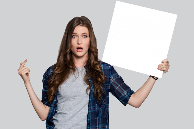 Girl holding white billboard