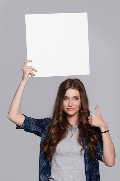 Girl holding white billboard