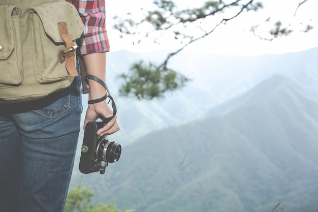 Free photo the girl holds a camera, hiking in the tropical forest, along with backpacks in the forest, adventure, travel, tourism, climbingม hike.