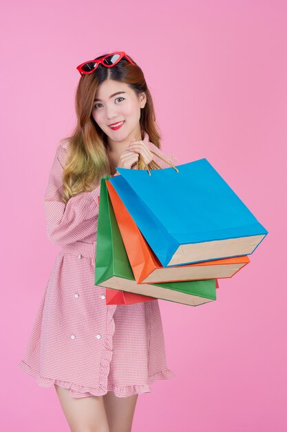 The girl holds a fashion shopping bag and beauty