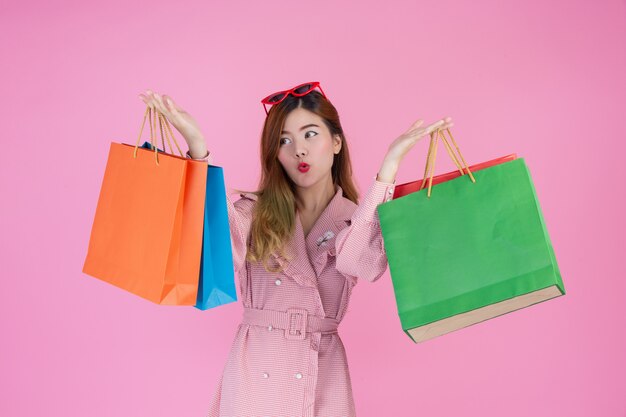 The girl holds a fashion shopping bag and beauty