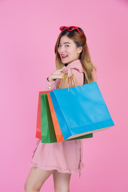 The girl holds a fashion shopping bag and beauty