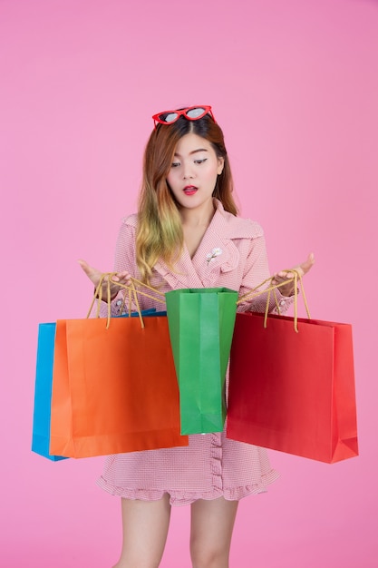 The girl holds a fashion shopping bag and beauty