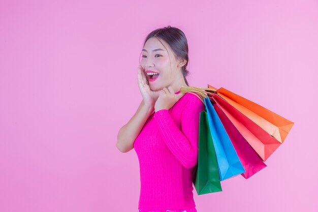 The girl holds a fashion shopping bag and beauty