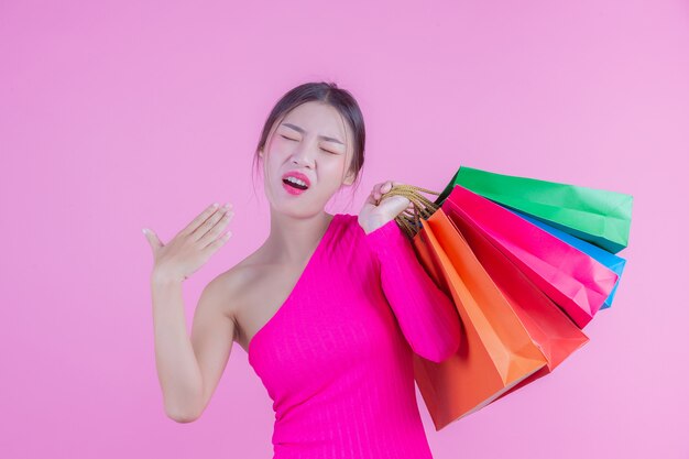 The girl holds a fashion shopping bag and beauty