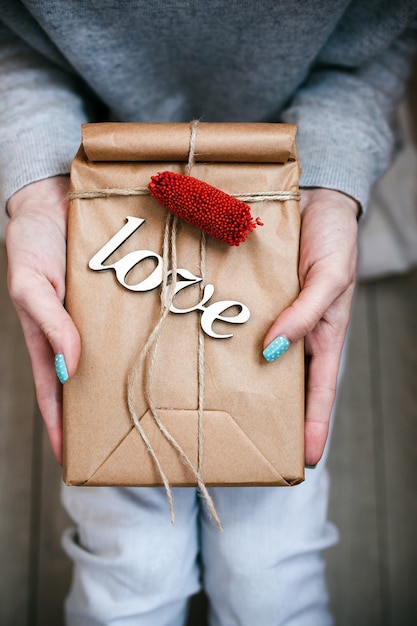 The girl holds in hands charming gift for her loved one