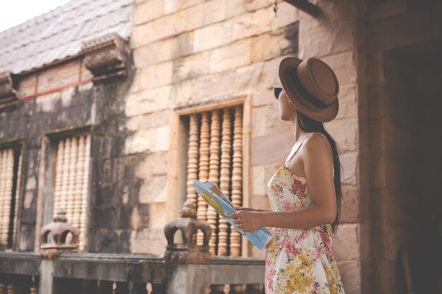 Girl holds a tourist map in the old town.