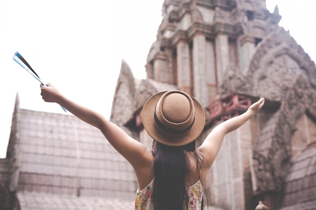 Girl holds a tourist map in the old town | Free Stock Photo