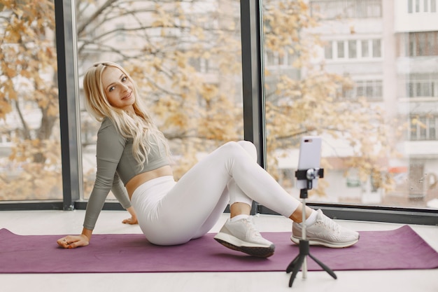 Girl at home. Woman make yoga. Lady shoot a video blog.