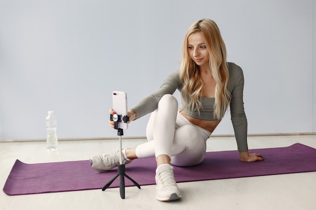 Girl at home. Woman make yoga. Lady shoot a video blog.