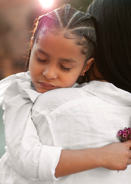 Girl hugging her mother outdoors