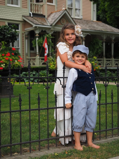 Free photo girl hugging a little boy from the shoulders