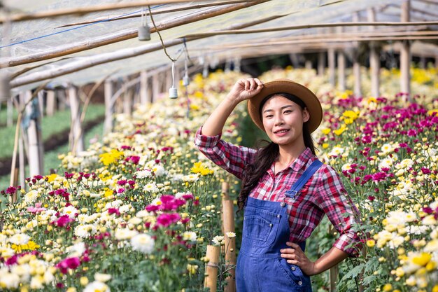 The girl is admiring the flowers in the garden.