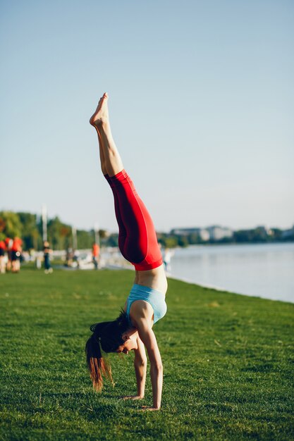 Girl is engaged in morning exercise in the park.