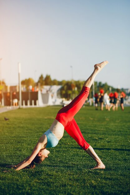 Girl is engaged in morning exercise in the park.