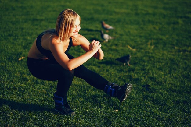 Girl is engaged in morning exercise in the park.