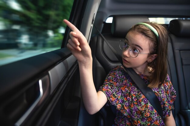 Free photo the girl is sitting in the car on the way to school