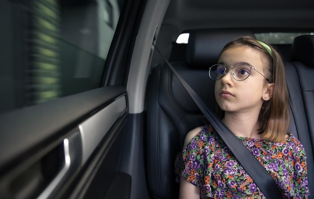 Free photo the girl is sitting in the car on the way to school